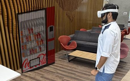 The room the demo runs in, before you put the headset on A participant in a Quest 3 facing the real vending machine the virtual one is anchored to