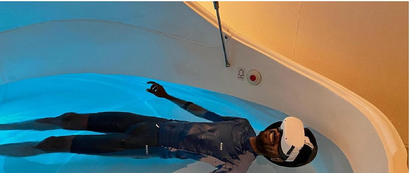 The study that turned into a company A participant floating in the tank wearing a headset. Real water for the body, virtual water for the head.