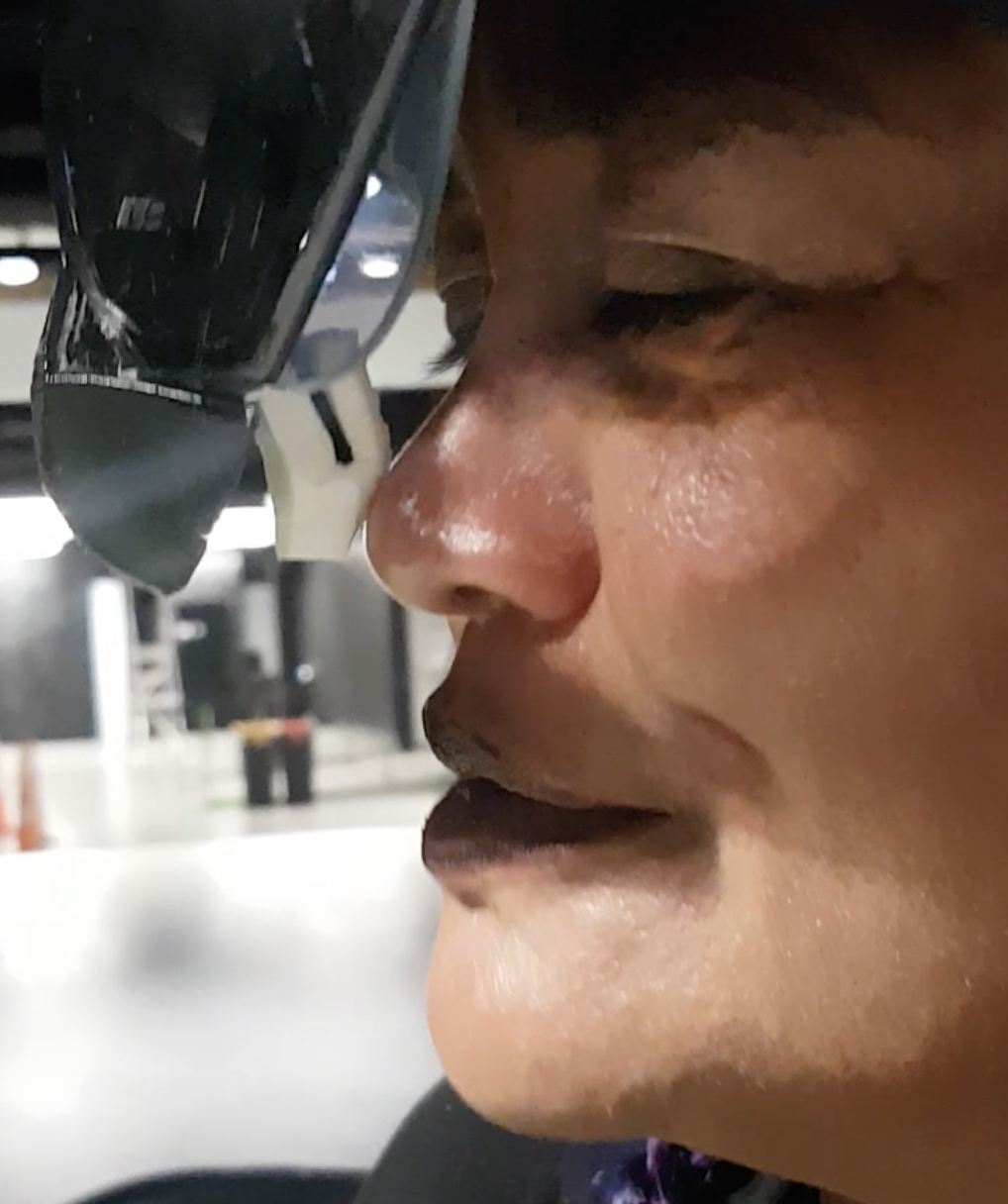 The sponge-coated SMA actuator, mounted to the headset, pressing gently against the nose The sponge-coated shape memory alloy actuator pressing the user's nose
